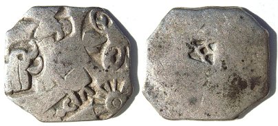 Silver punch mark coin of the Maurya empire, with symbols of wheel and elephant. 3rd century BC